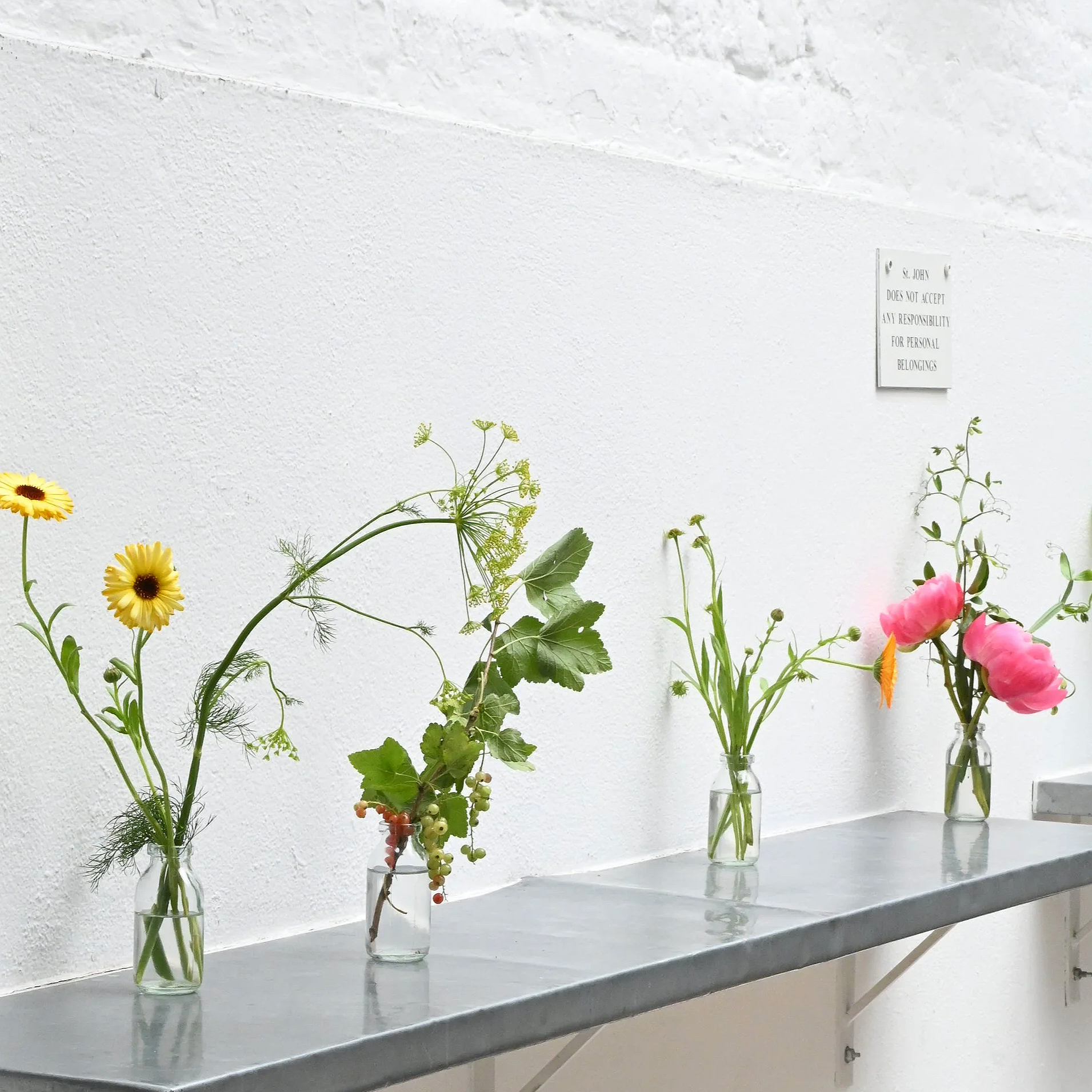 Seasonal bud vase arrangements for a June wedding