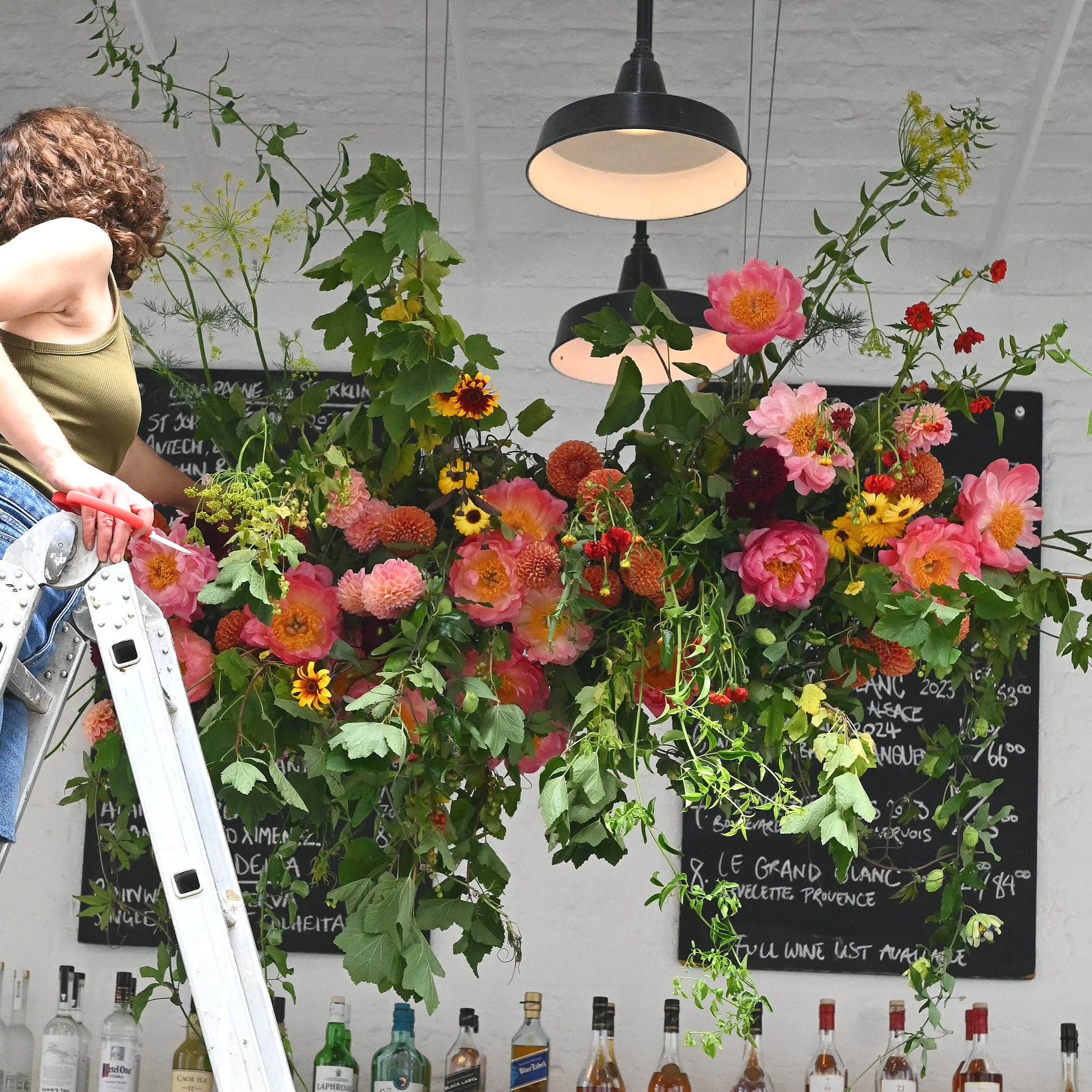 Florist working on a seasonal summer flower cloud
