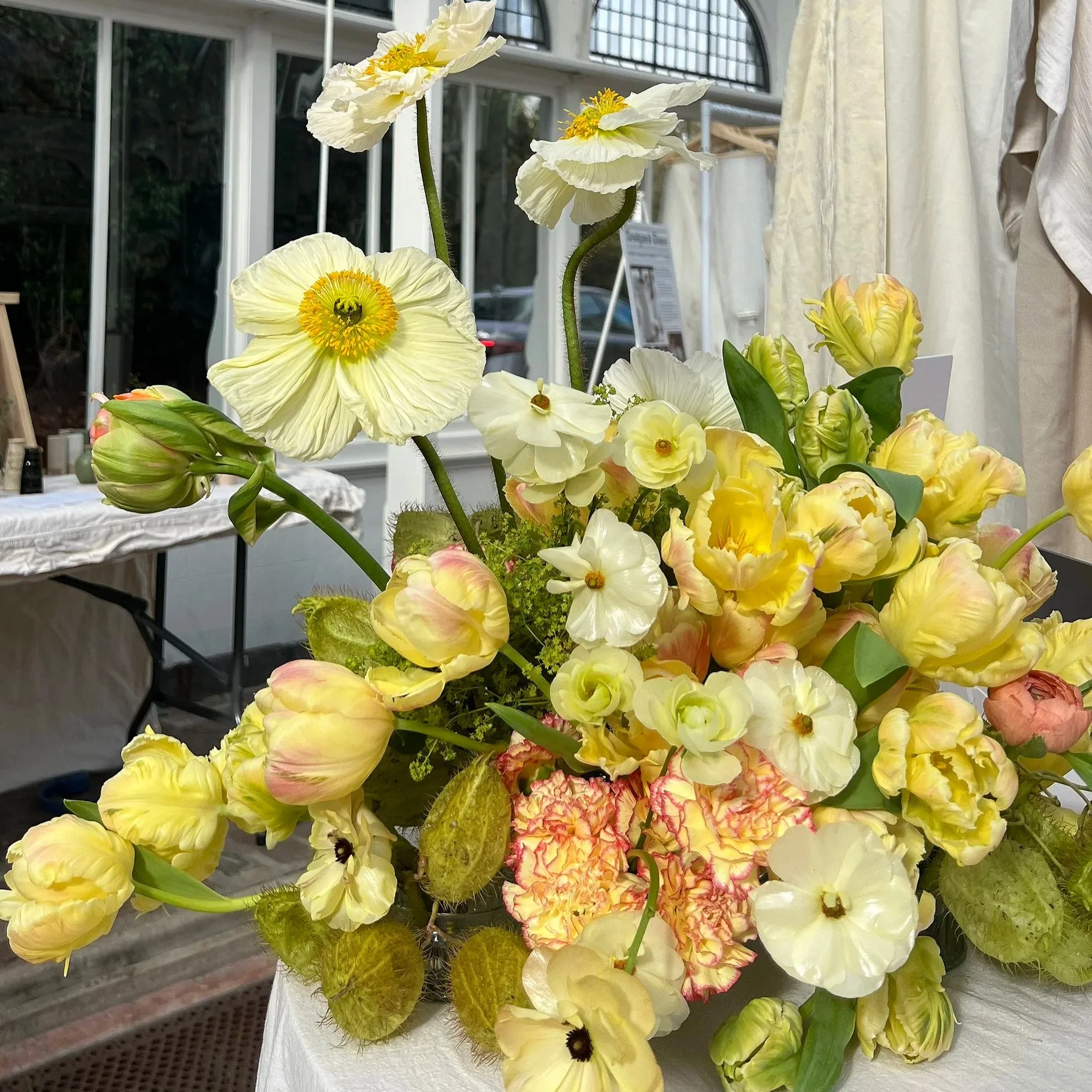 Spring statement floral arrangement filled with poppies, tulips, carnations and butterfly ranunculus