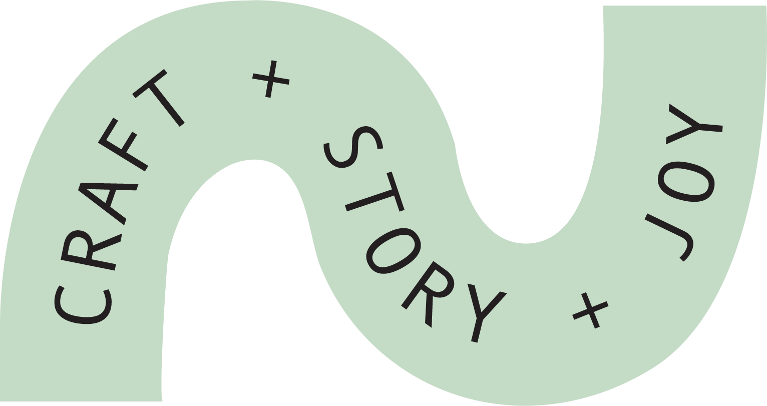 Green infinity-shaped banner with the words 'CREATE + STORY + JOY' written in black capital letters along the curve.