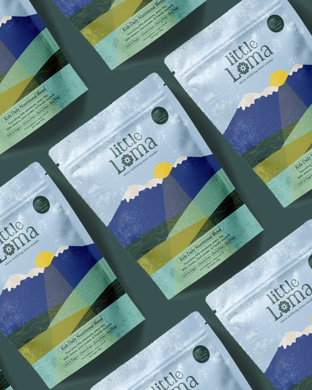 Multiple packages of Little Lama Kid's Daily Nutritional Blend featuring a mountain and sunrise illustration on the packaging.