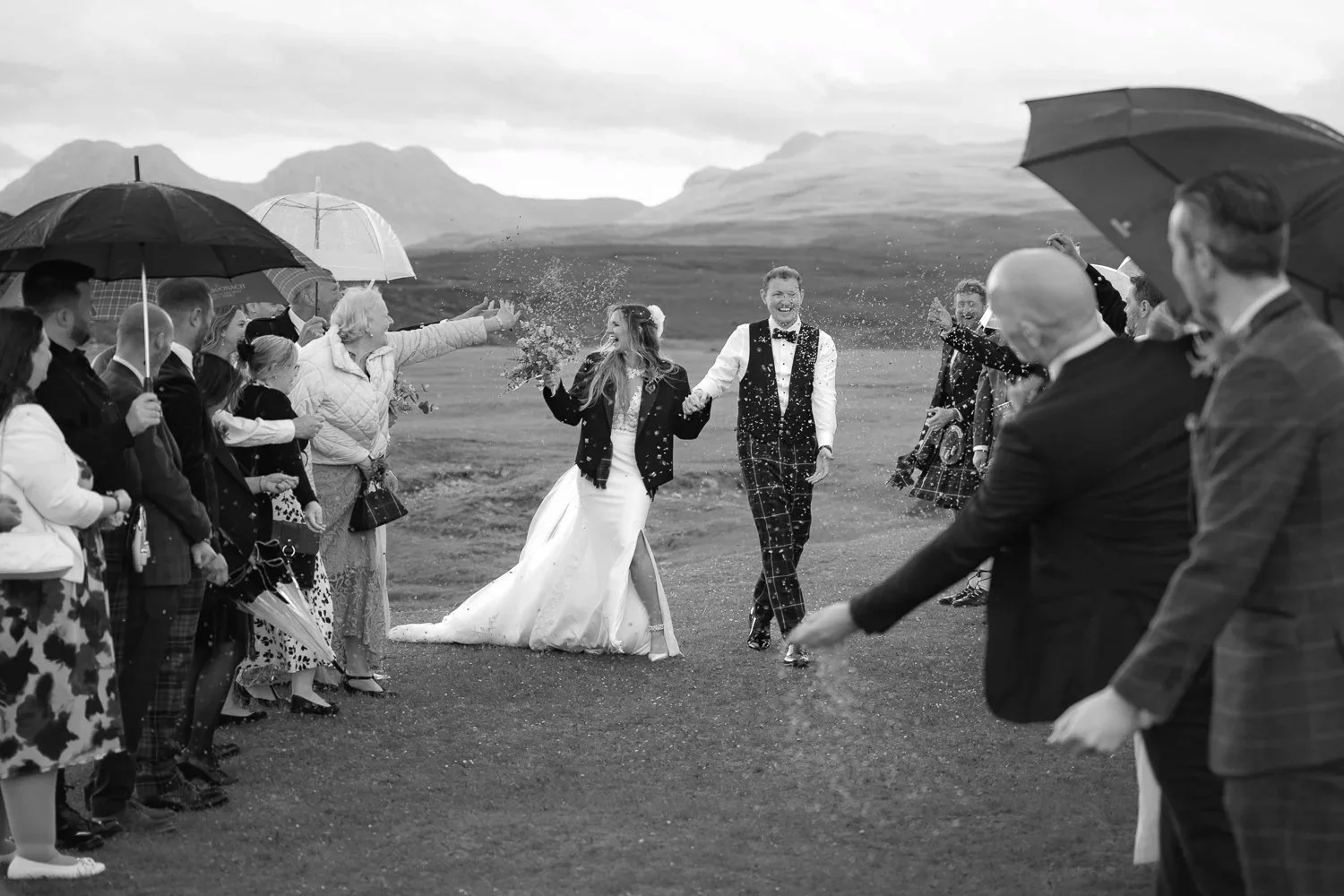 Groom and Bride walking through confetti.