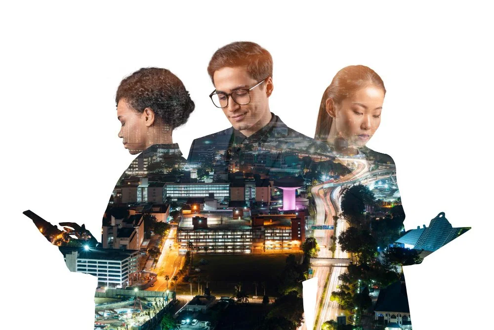 A double-exposure digital collage featuring three diverse professionals looking downward with somber expressions. Superimposed over their silhouettes is a glowing, complex nighttime cityscape with high-rise buildings and busy highways.