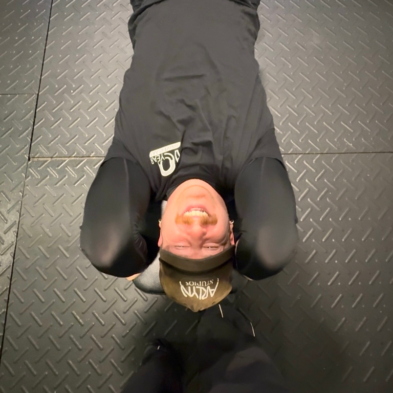 Man smiling working out on bench with trainer