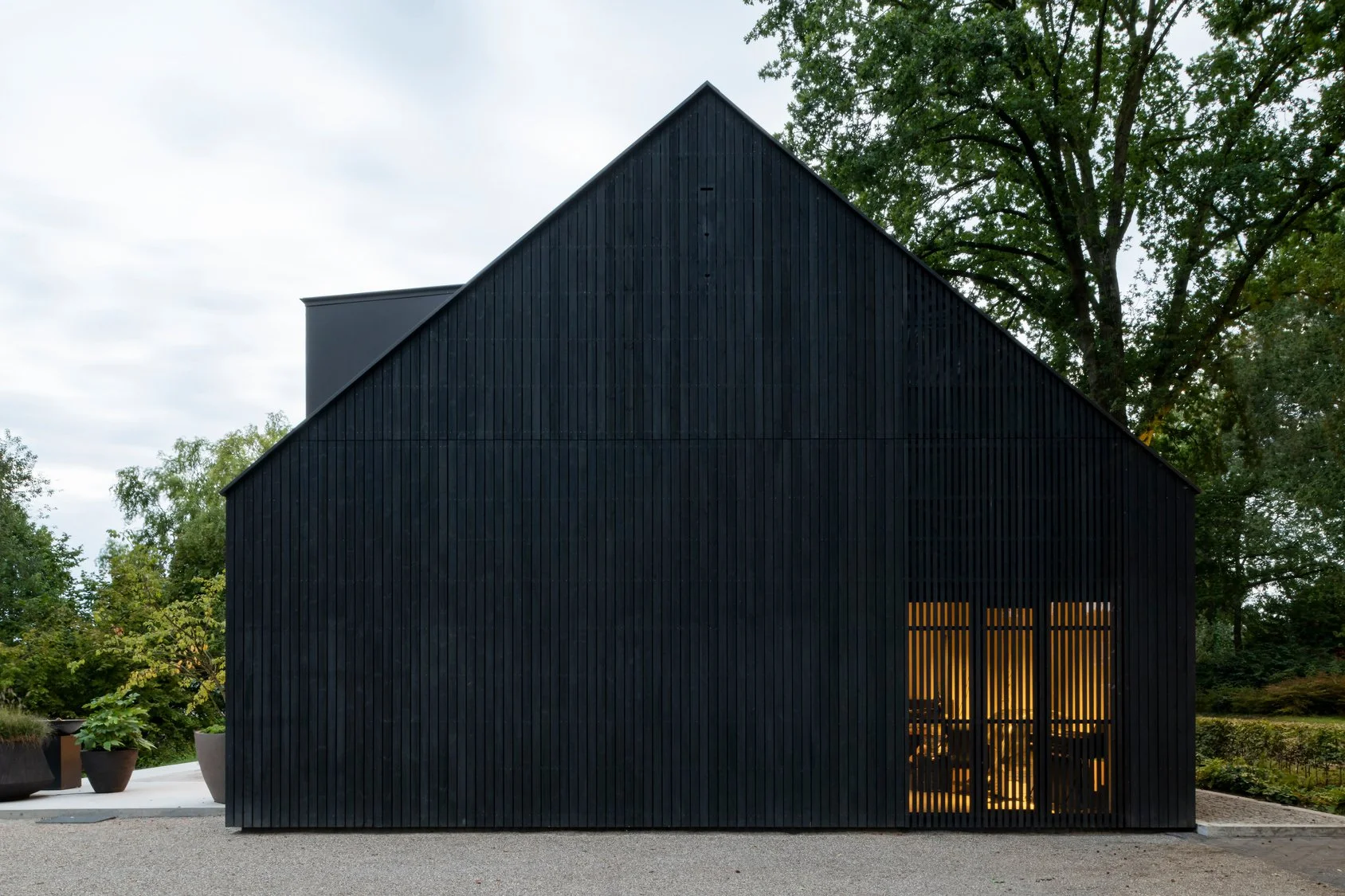 Contemporary new build office with black timber cladding, dramatic gabled façade and vertical timber detailing.