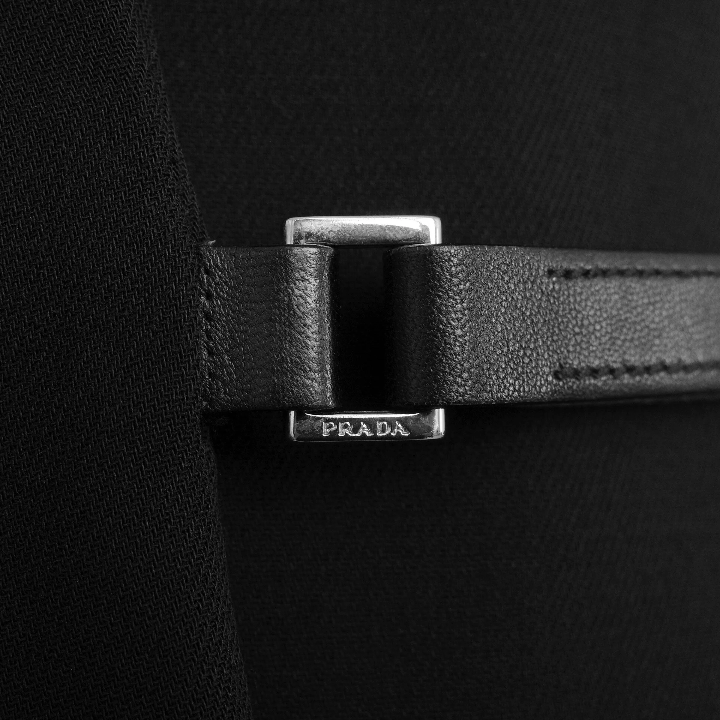 Prada FW 1999 wool blazer with a leather buckle strap velcro closure and leather trims. Size IT 40 / UK 8. Available at Artefact Archive.