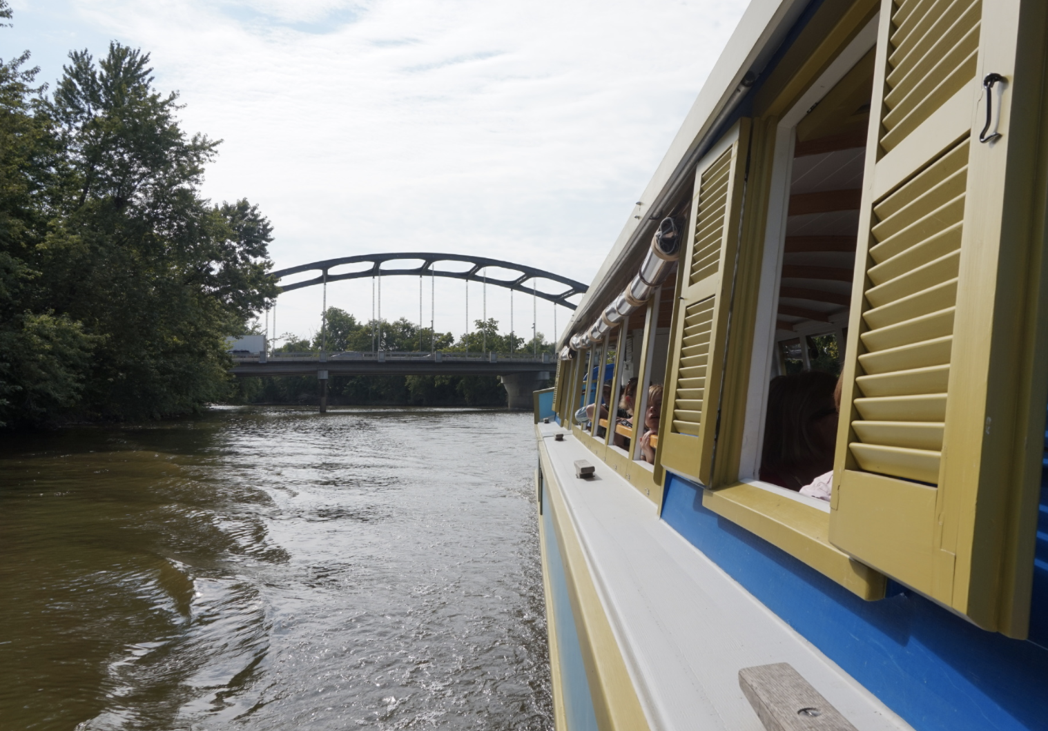 A view of the side of the Sweet Breeze boat and the river.