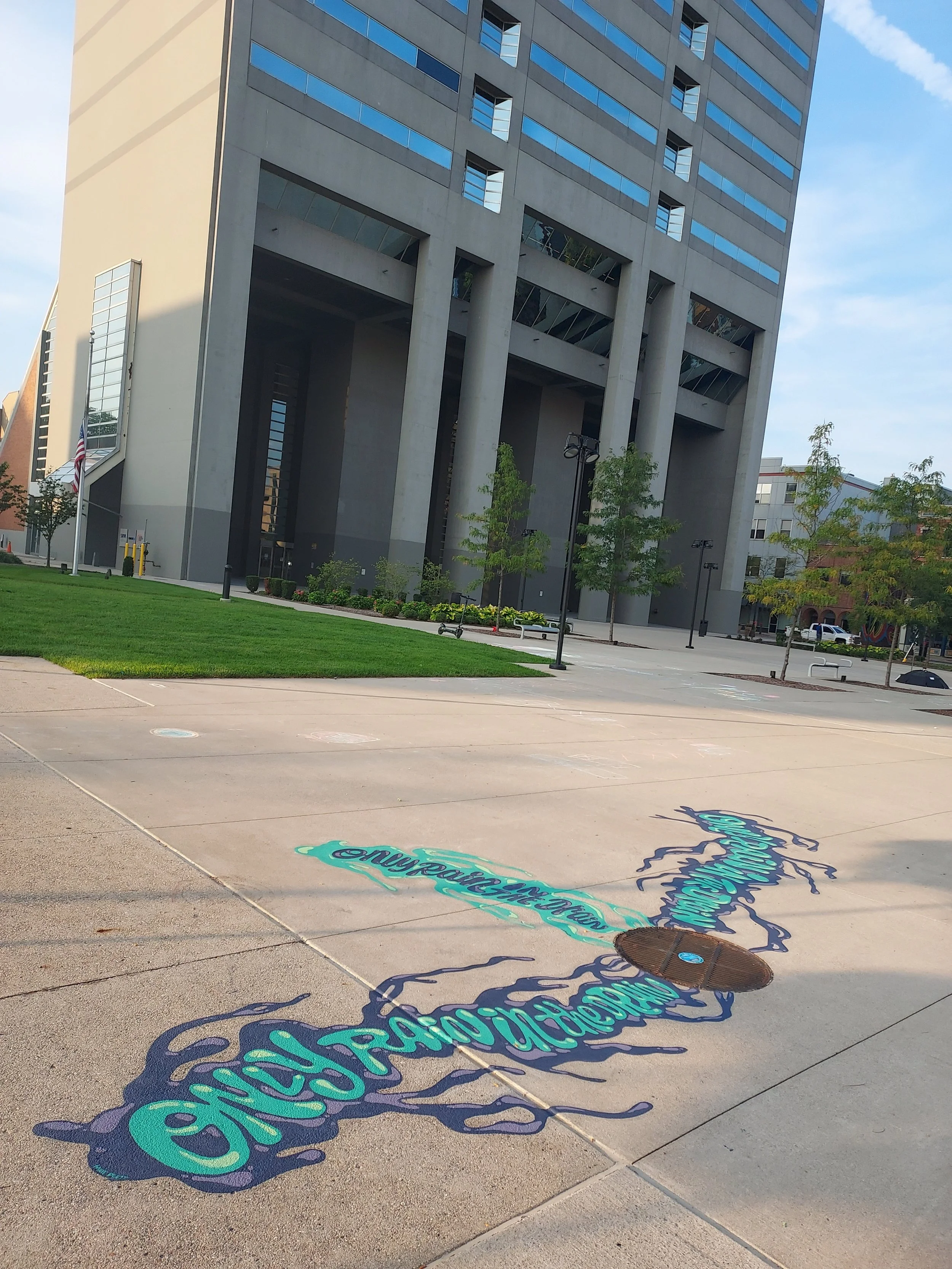 Drain art that says "only rain in the drain".