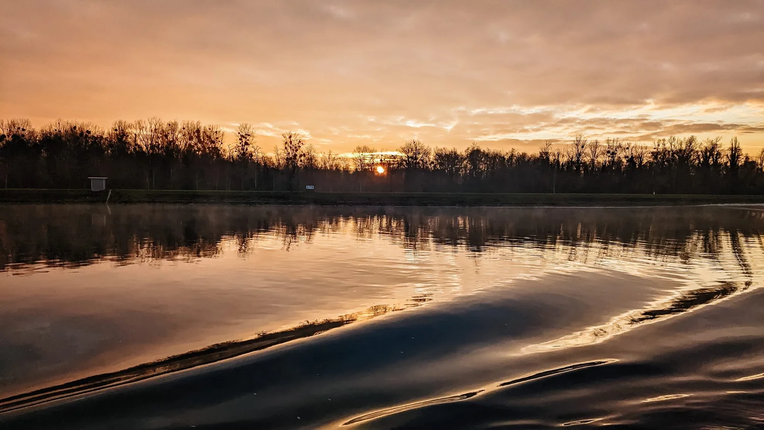 Sunset over the Rhine, seen from the stern of a river cruise ship