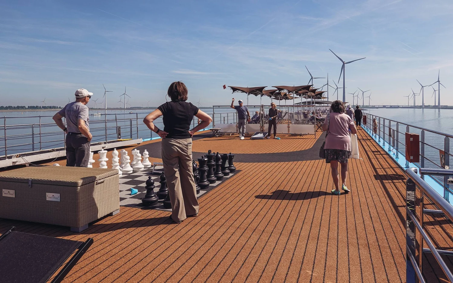 Guests on the top deck of a river cruise ship on a sunny morning