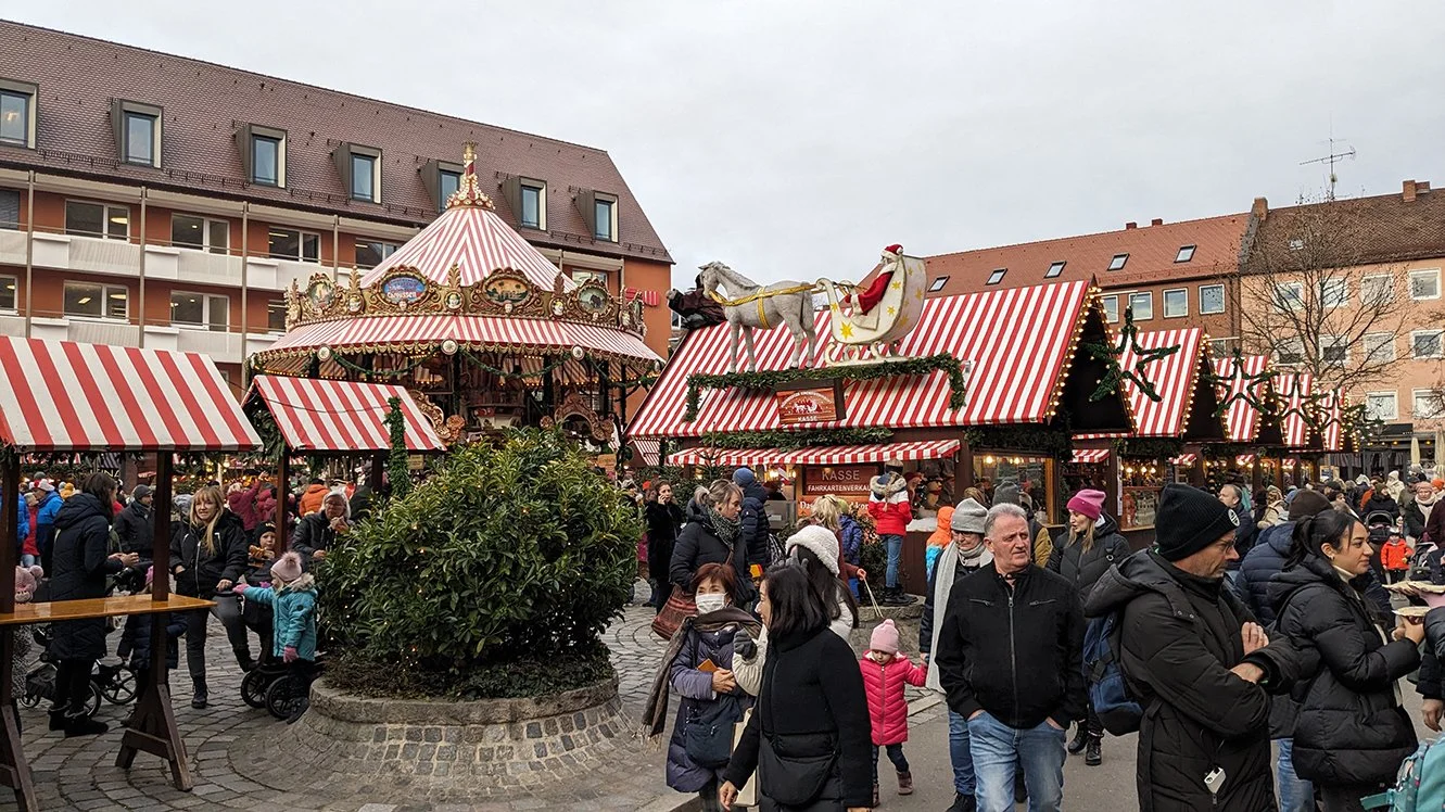 The Christmas market in Nuremberg at dusk, stalls lit for the season