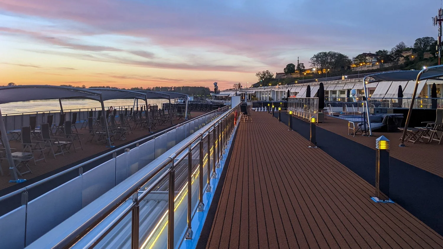 The empty sundeck of a river cruise ship at dusk