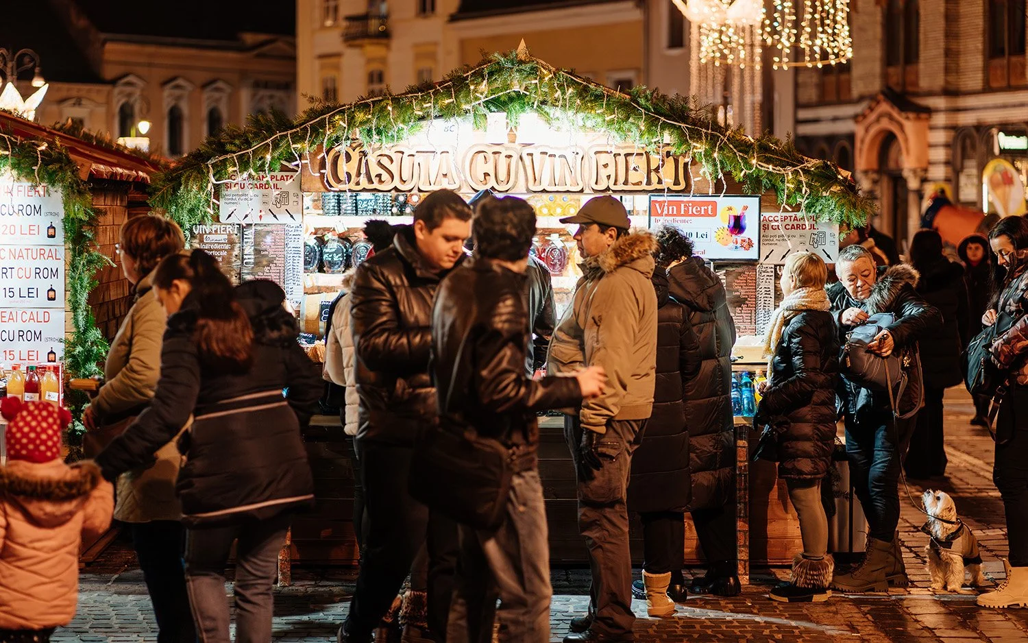 Crowds filling a Christmas market lane in the evening