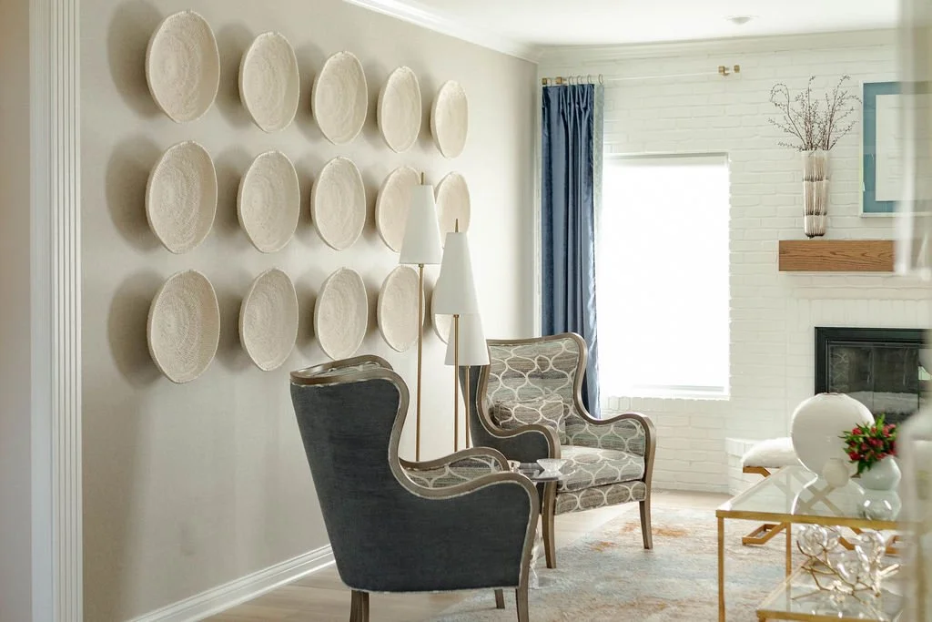 Neutral sitting area with textured wall plates and accent chairs Newbridge