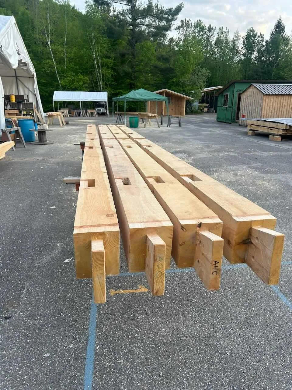 Four tie beams on sawhorses with finished joinery