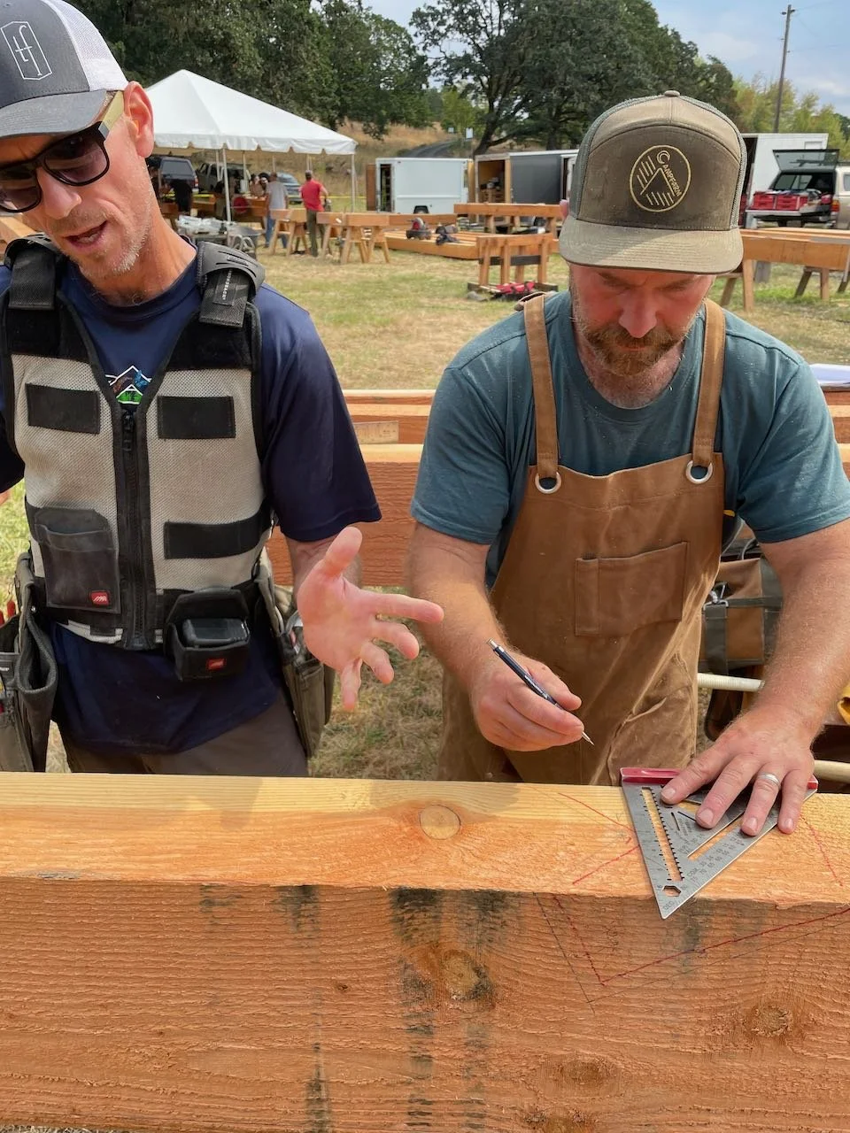Carpenters figuring out the right angle to draw on a timber