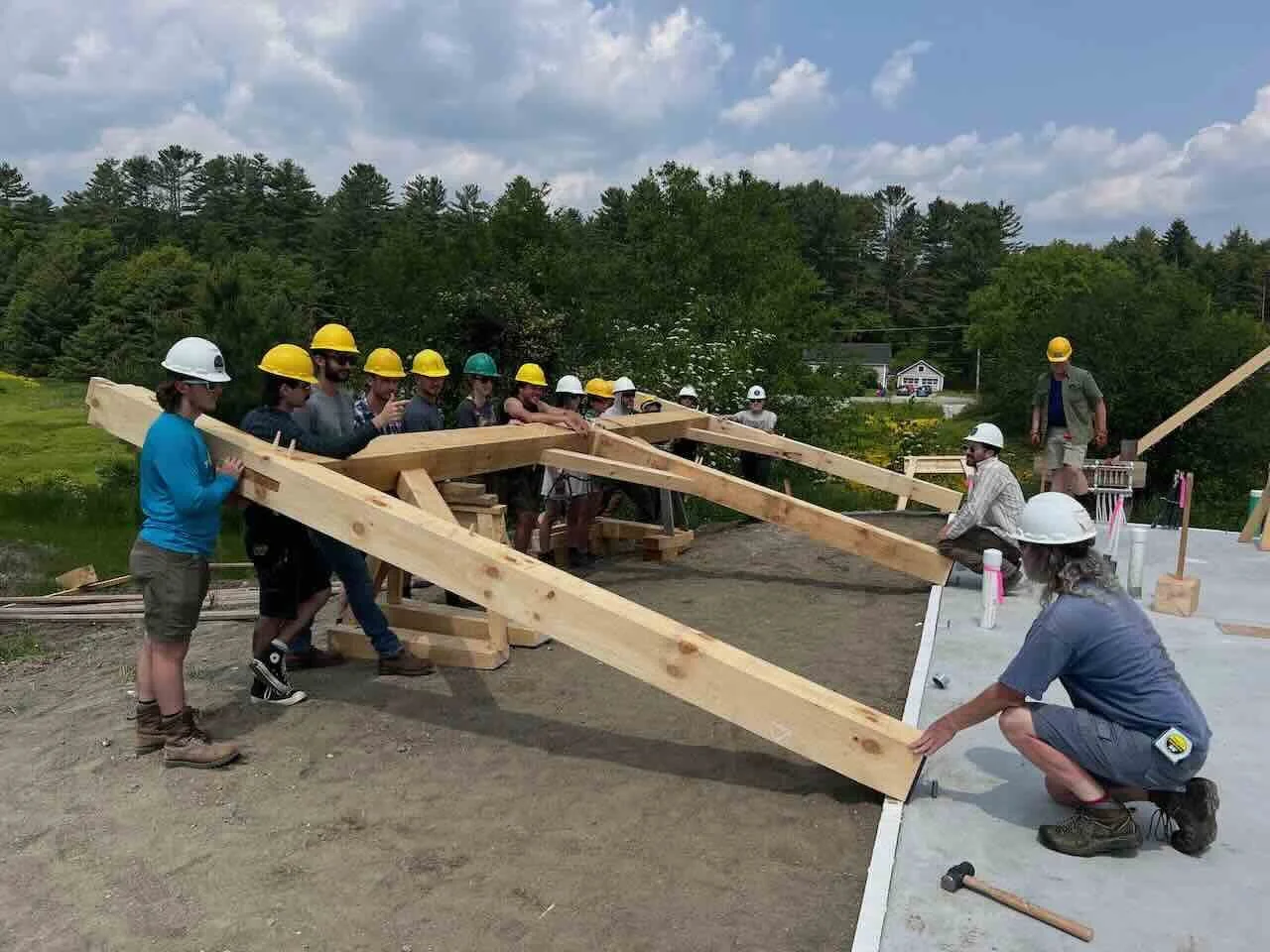 Class lifts a heavy timber framed bent together