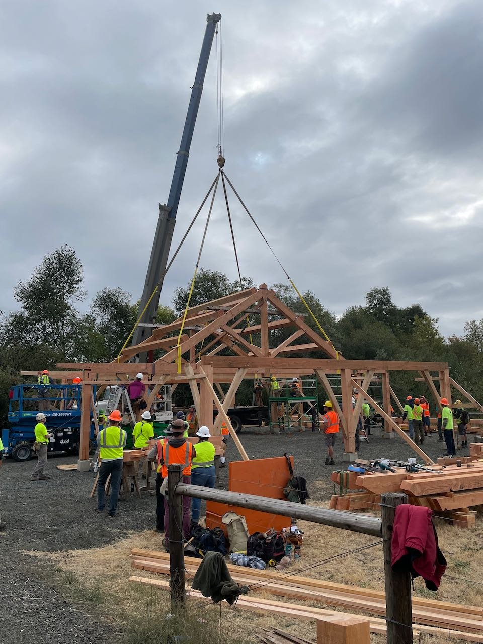 Crane lifts large timber framed roof section