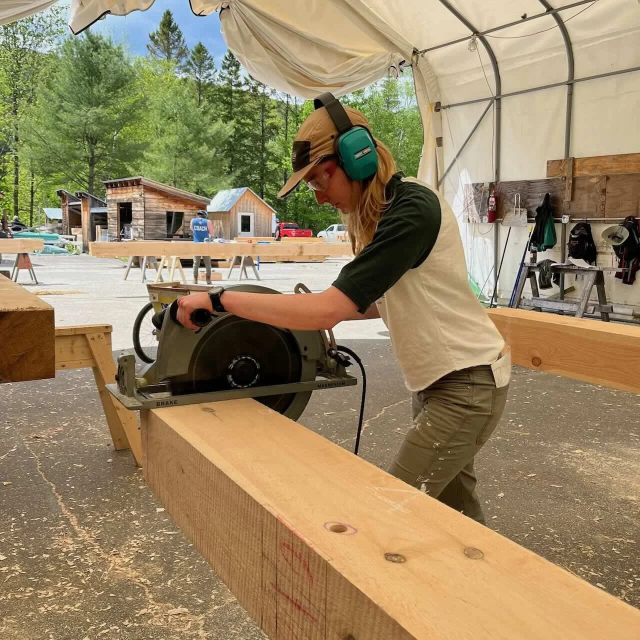 Timber framing student uses huge circular saw