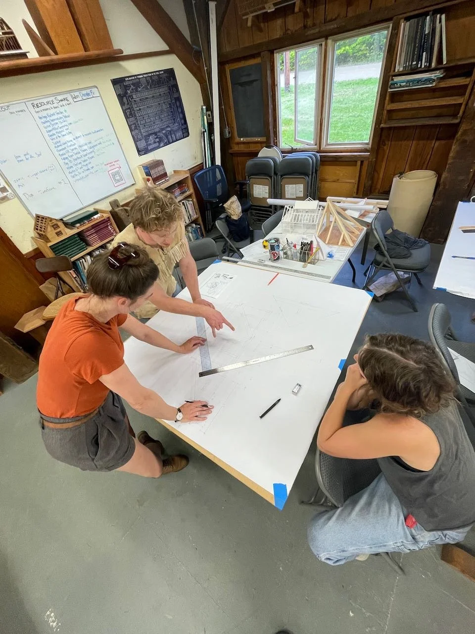 Students discuss a drawing of hip roof