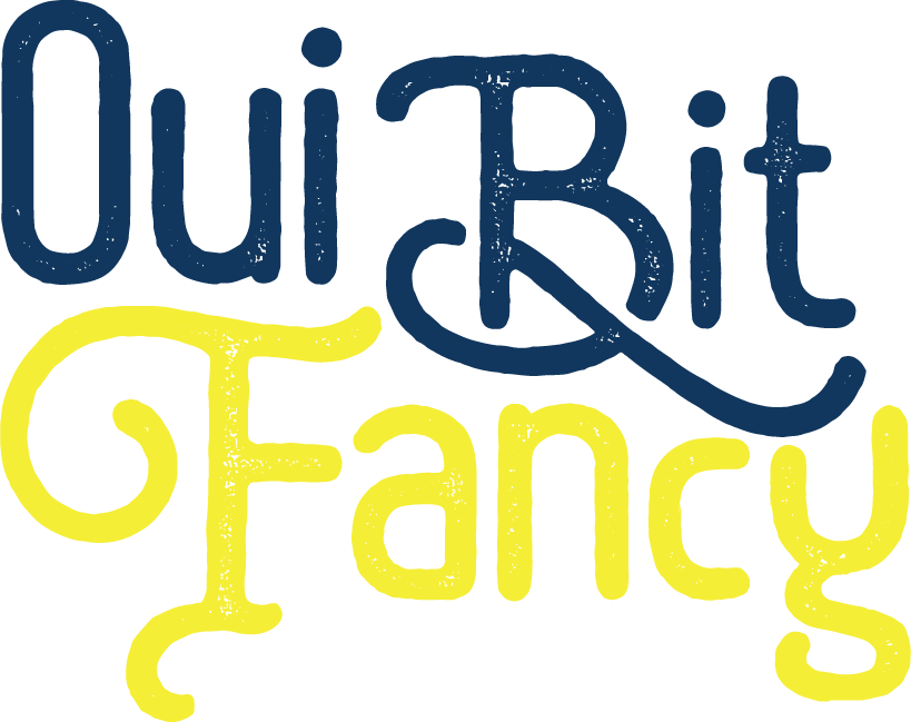 Text that says "Oui BIt Fancy" with "Quit" in dark blue, "Bit" in dark blue, and "G Fancy" in bright yellow, in a playful handwritten style.