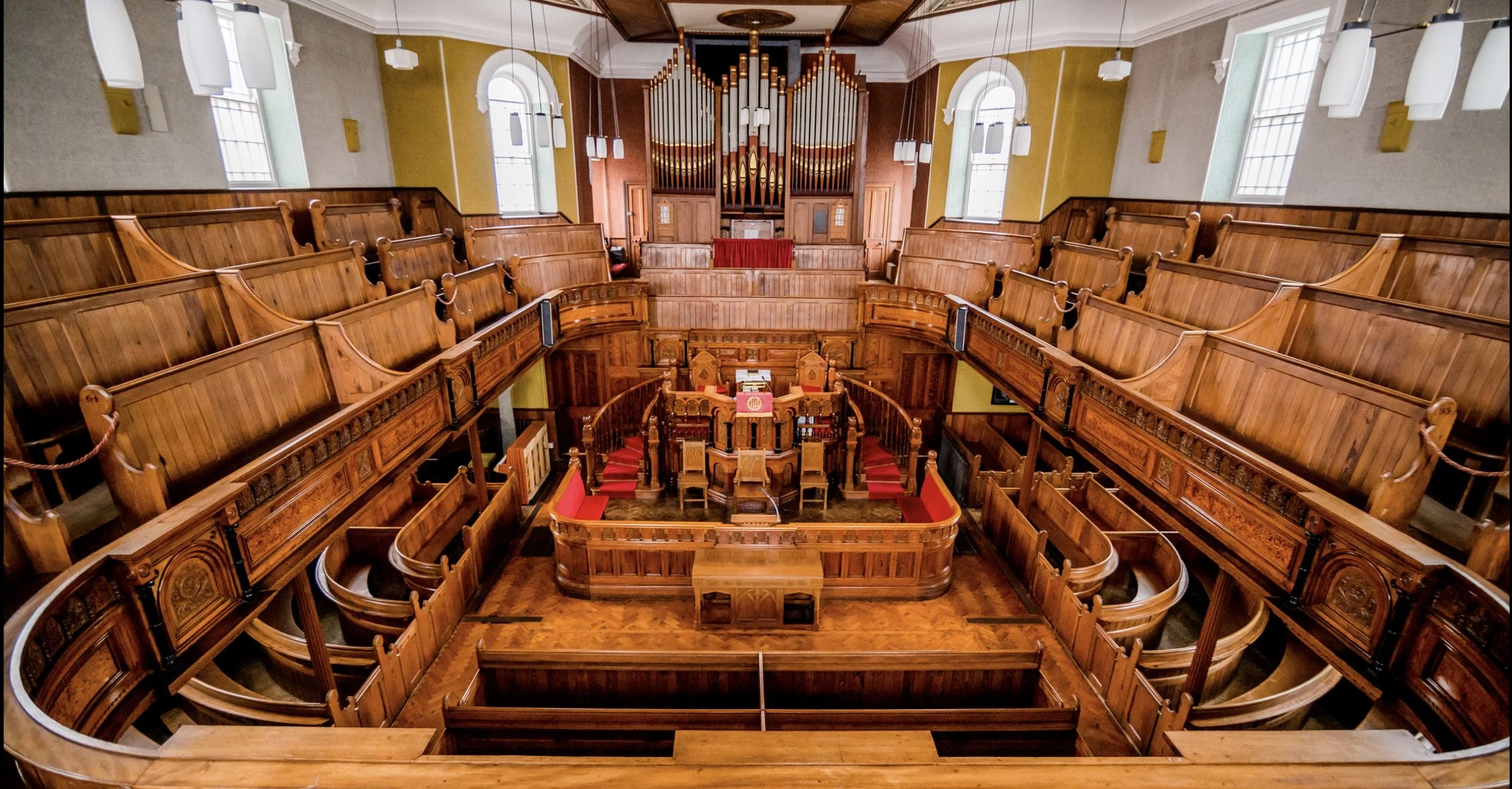 Interior of an empty traditional church with wooden pews and pulpit