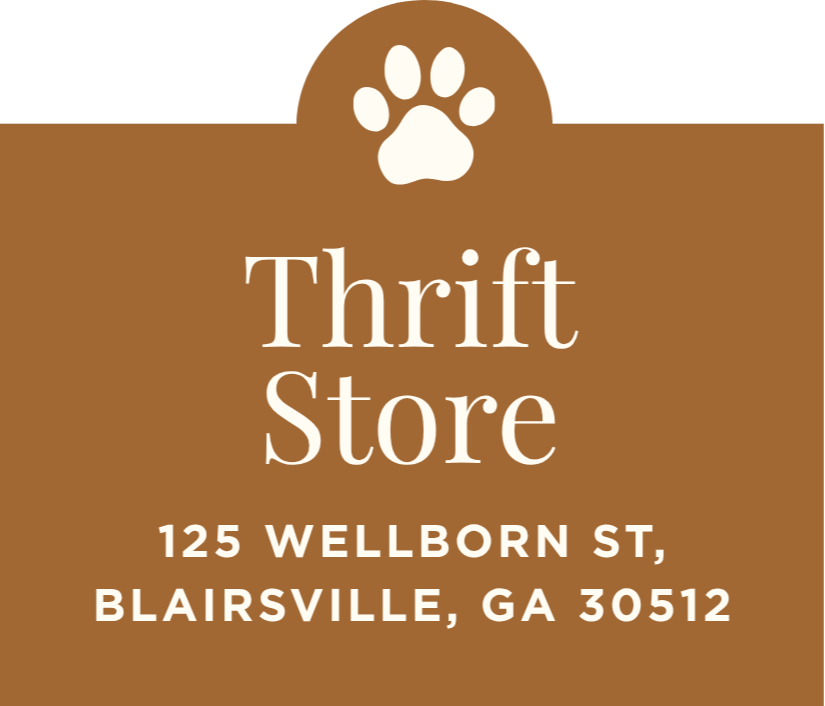 Sign for a thrift store with a paw print at the top, located at 125 Wellborn Street, Blairsville, GA 30512.