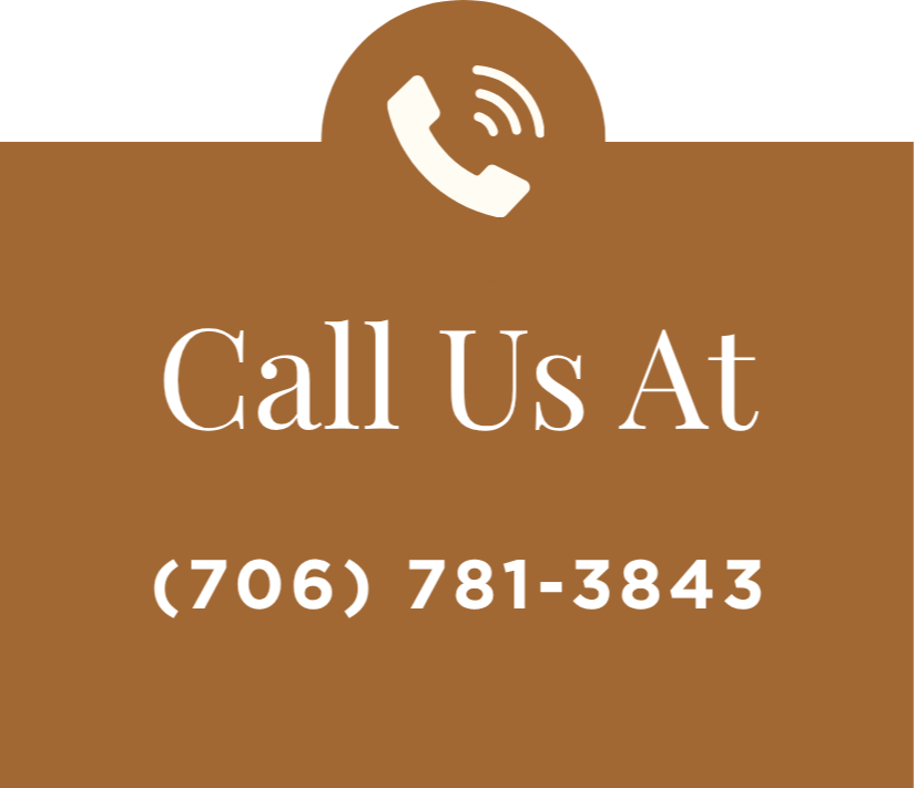 Brown sign with white text and a phone icon, saying "Call Us At (706) 781-3843".
