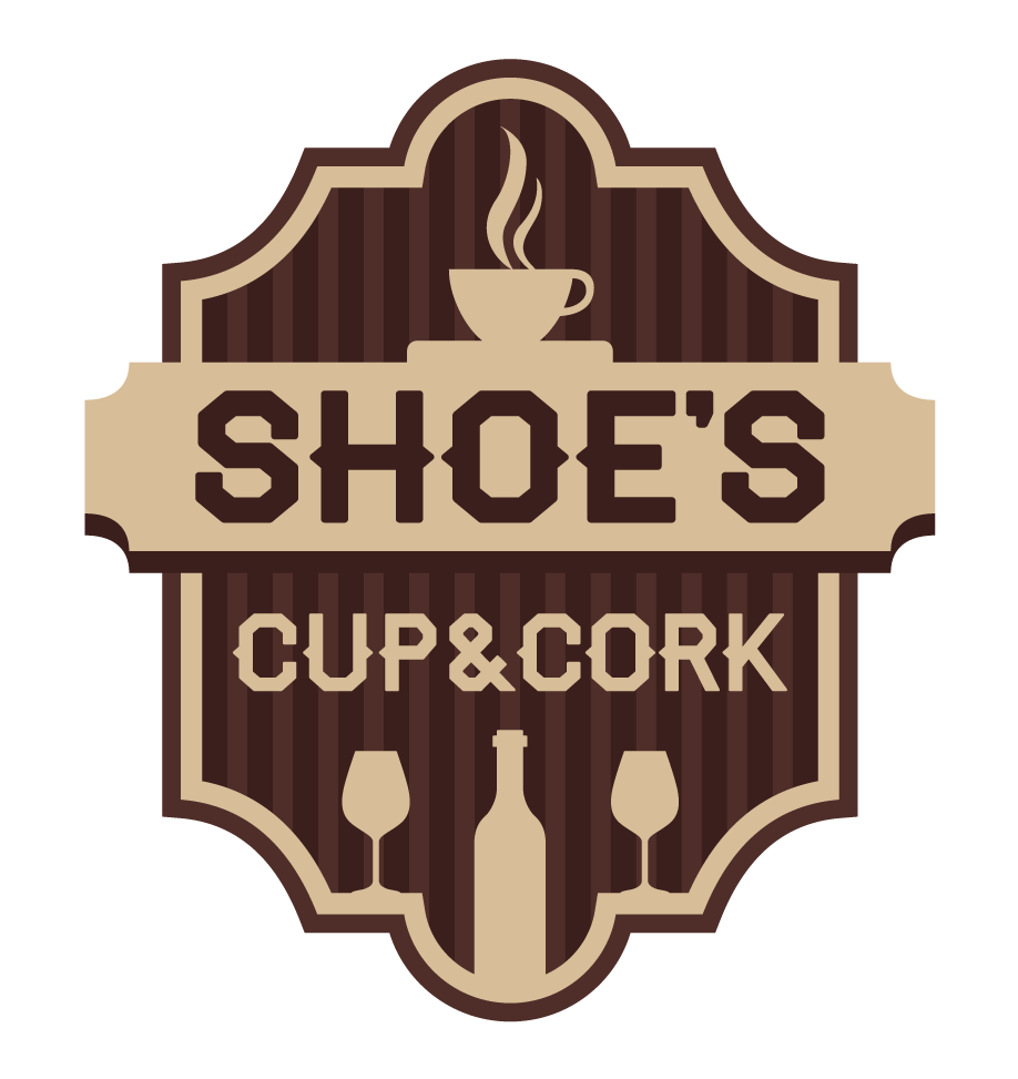 A logo for a business called Shoe's Cup & Cork, featuring a coffee cup with steam at the top, and wine glasses and a wine bottle at the bottom, with a brown, beige, and cream color scheme.