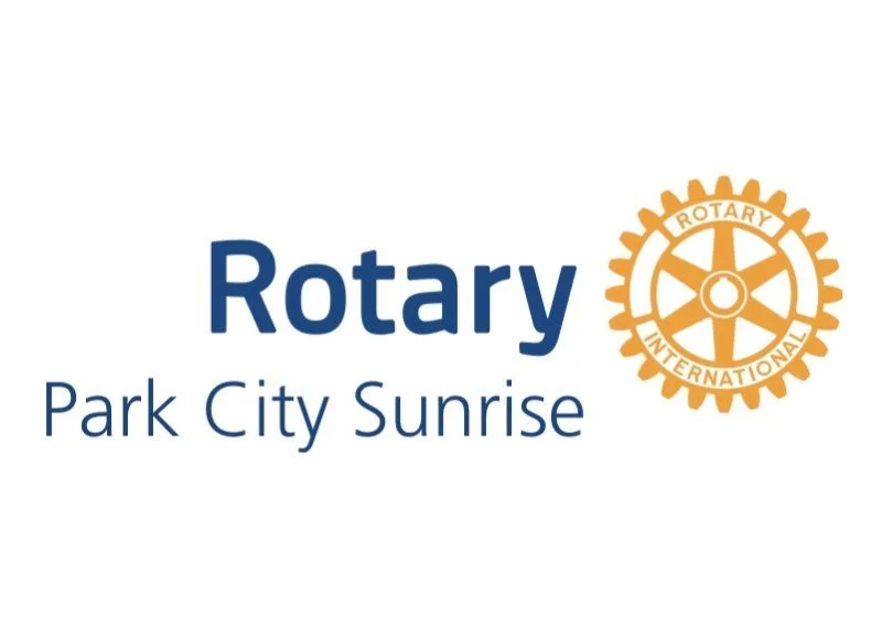 Logotipo do Rotary International com o texto «Rotary Park City Sunrise»