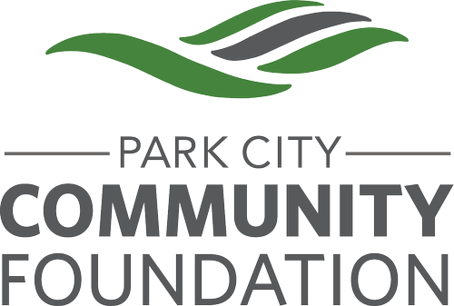 Logo for Park City Community Foundation featuring green and gray stylized leaves above the organization name.