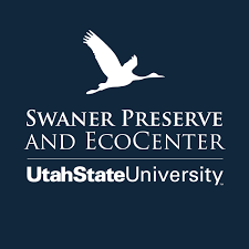 Logo of Swaner Preserve and EcoCenter at Utah State University featuring a white flying swan silhouette on a dark blue background with text.