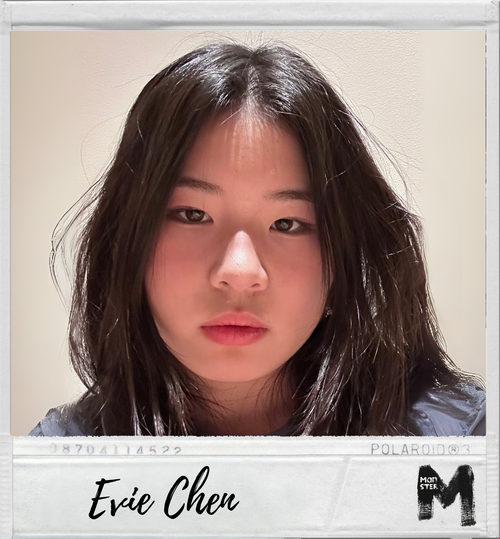 A young woman with long dark hair and a serious expression taking a Polaroid photo.