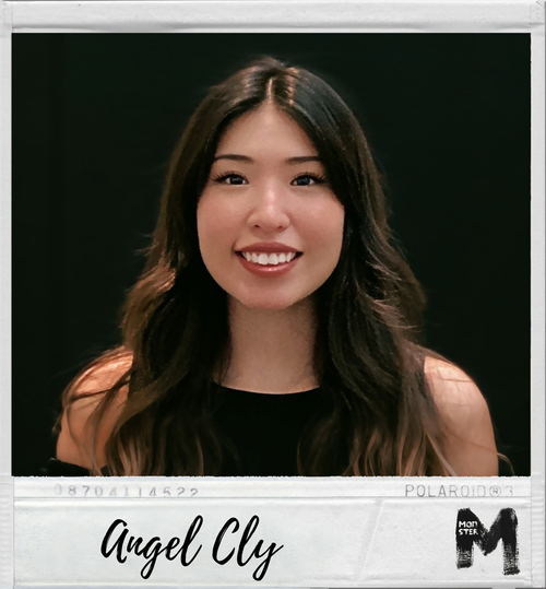 A young woman with long, wavy dark hair smiling at the camera, wearing a black sleeveless top, photo appears to be a Polaroid picture with the name 'Angel Cly' written at the bottom.