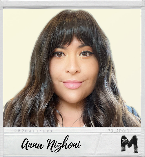 A woman with dark brown hair and bangs, smiling softly at the camera, with a Polaroid-style frame displaying the name Anna Nizhoni and an icon resembling a camera.