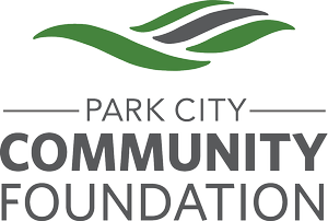 Logo of the Park City Community Foundation featuring stylized green and black leaves.