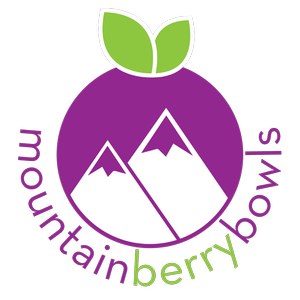 Logo with a purple circle featuring white mountain peaks and green leaves at the top, with the words "mountain", "berry", and "bowl" surrounding it.