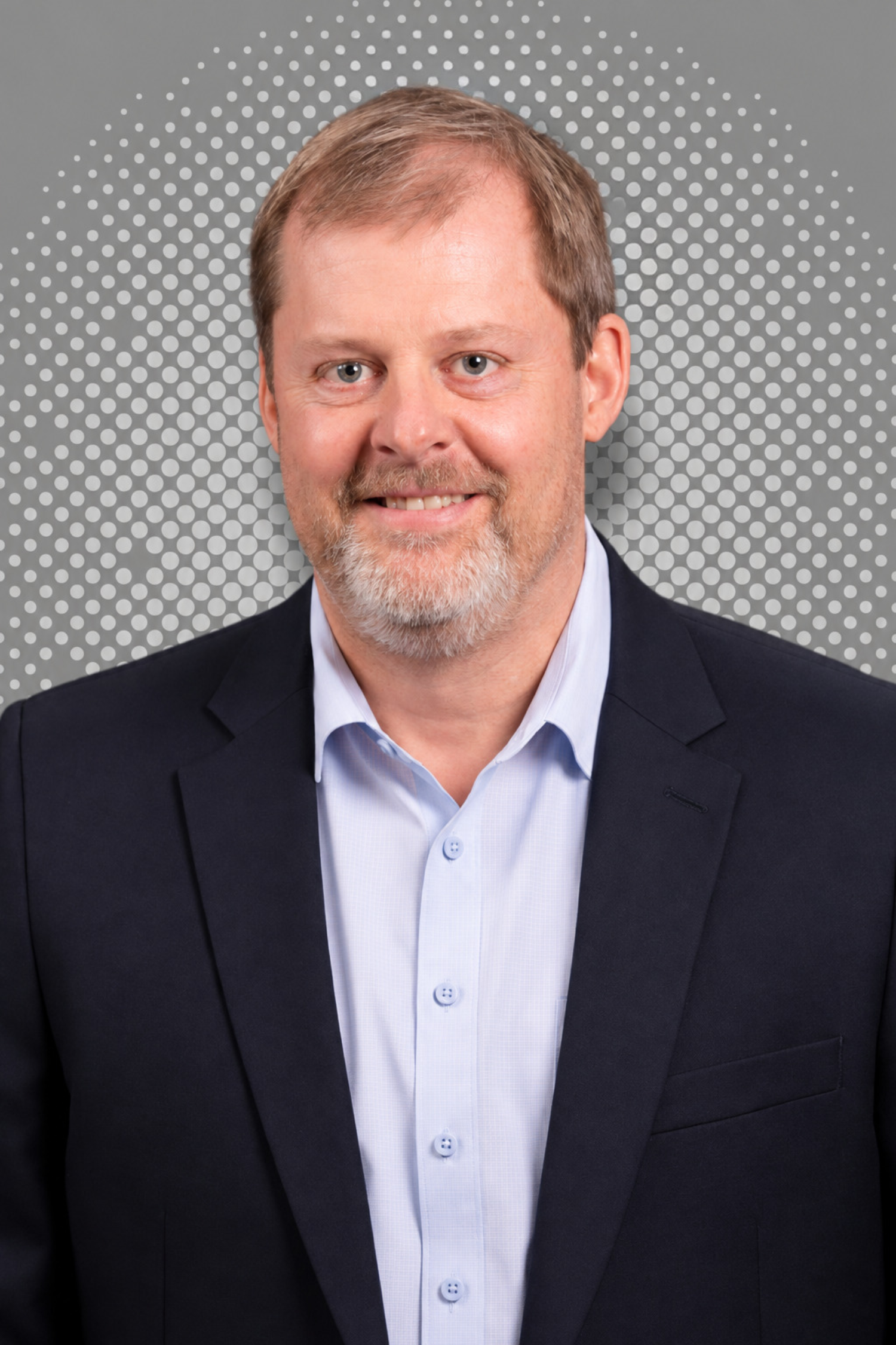 Man in a suit with a polka dot background