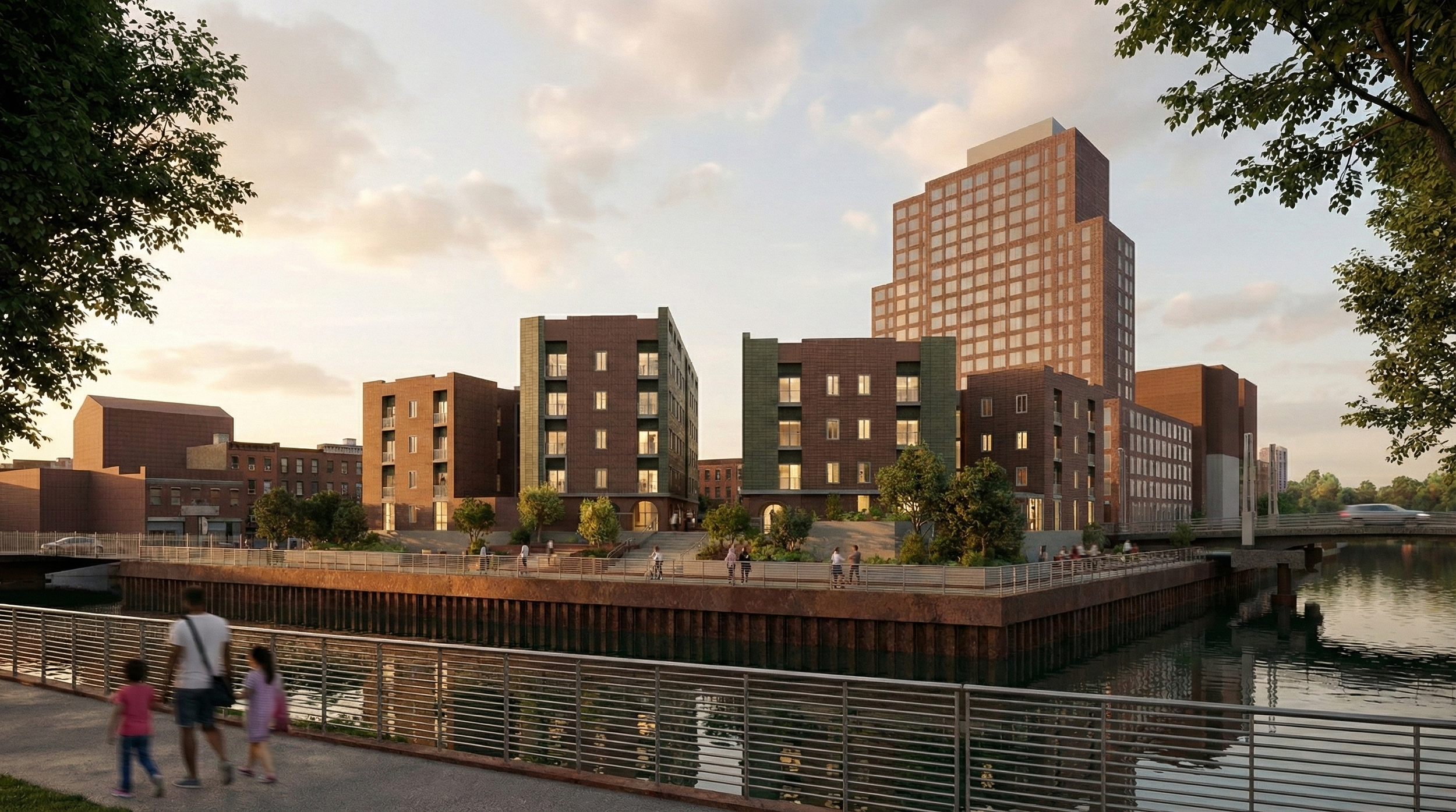 A riverside cityscape at sunset with modern multi-story buildings, trees, a bridge, and people walking along the riverbank.