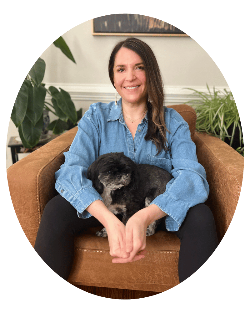 Melissa Rolfes, therapist, sitting with her dog in a warm and relaxed setting