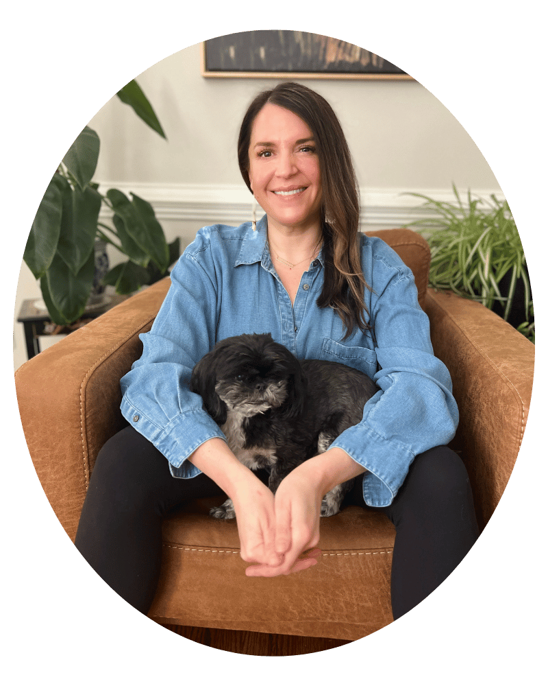 Melissa Rolfes, licensed therapist, sitting with her dog in her home office
