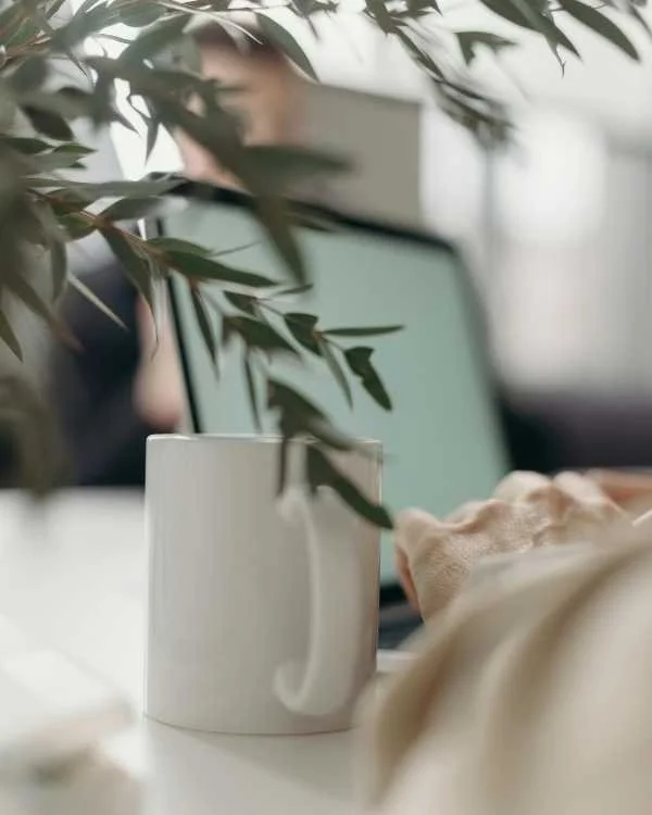 laptop and coffee mug in a calm home workspace for online therapy