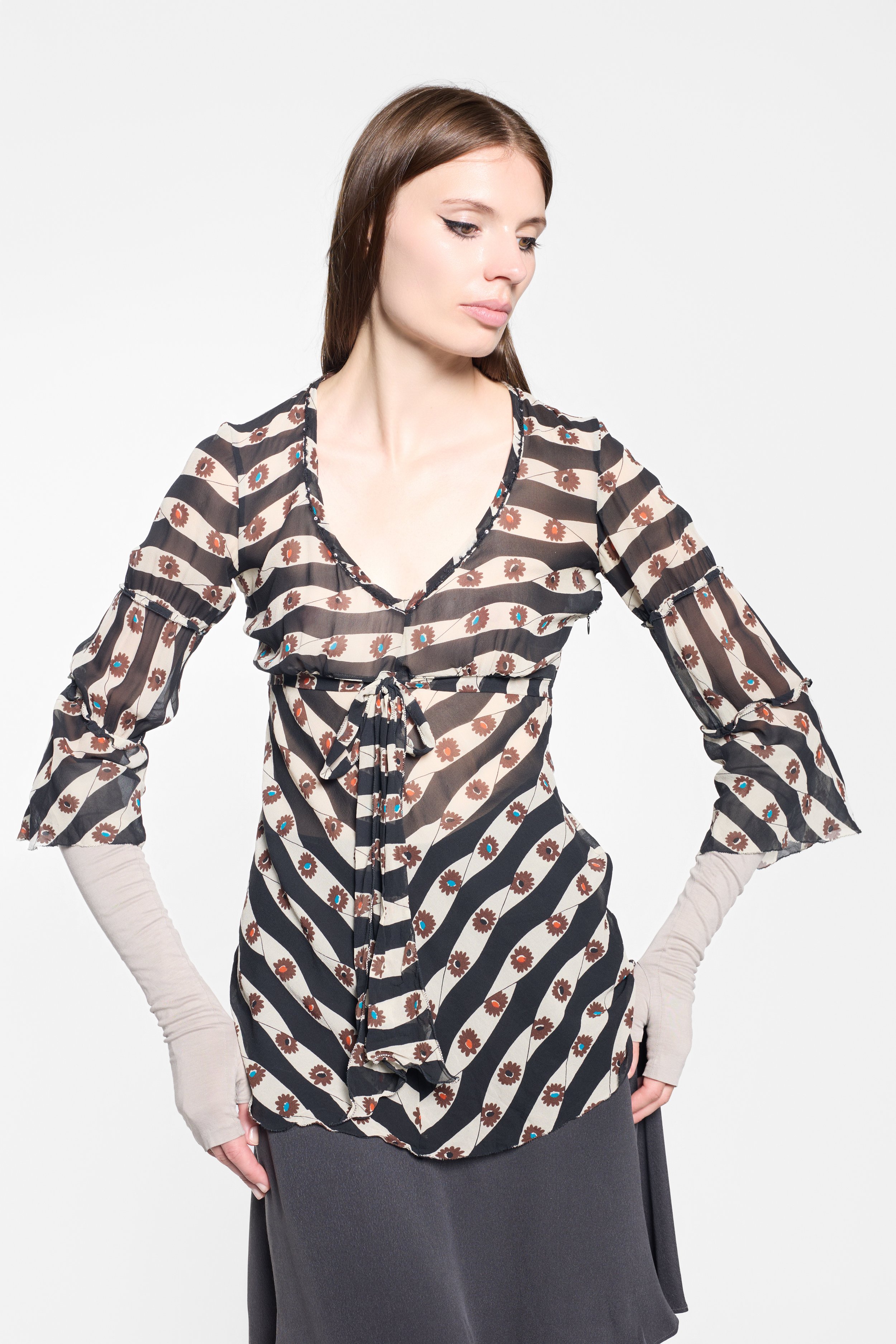 Close-up of ruffled trim and sheer printed silk on Kristina Ti top