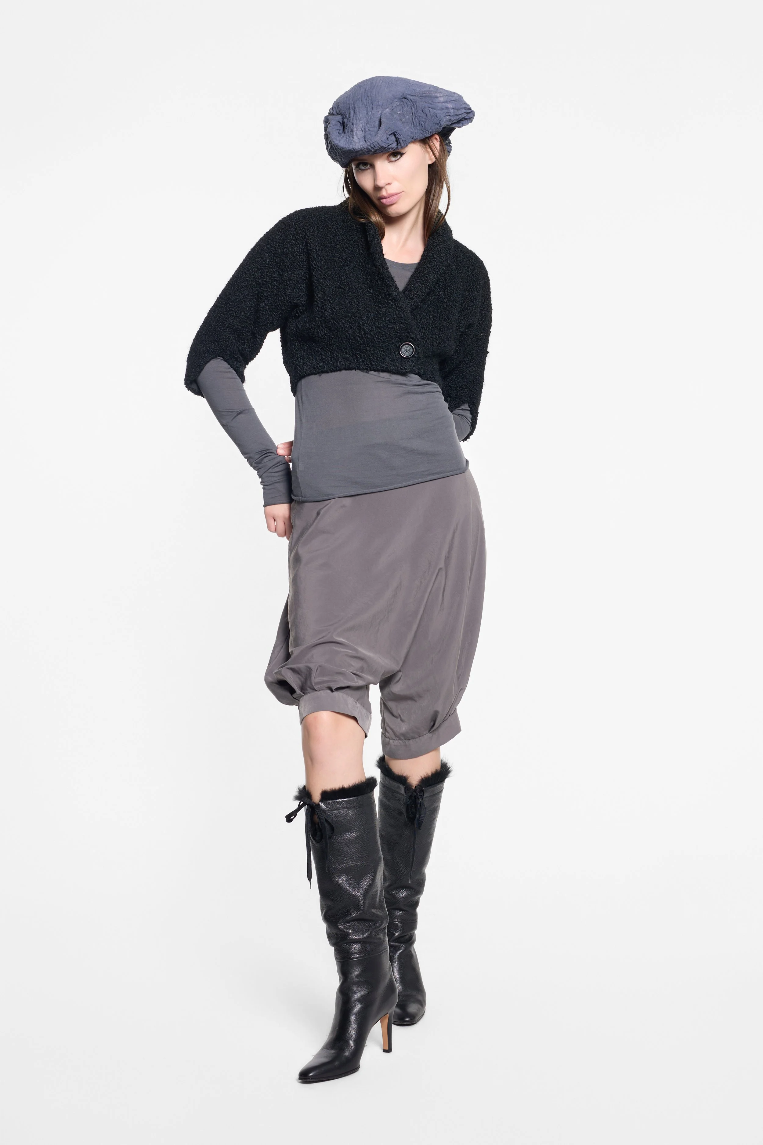 Grey minimalist designer top with elongated sleeves and sheer finish
