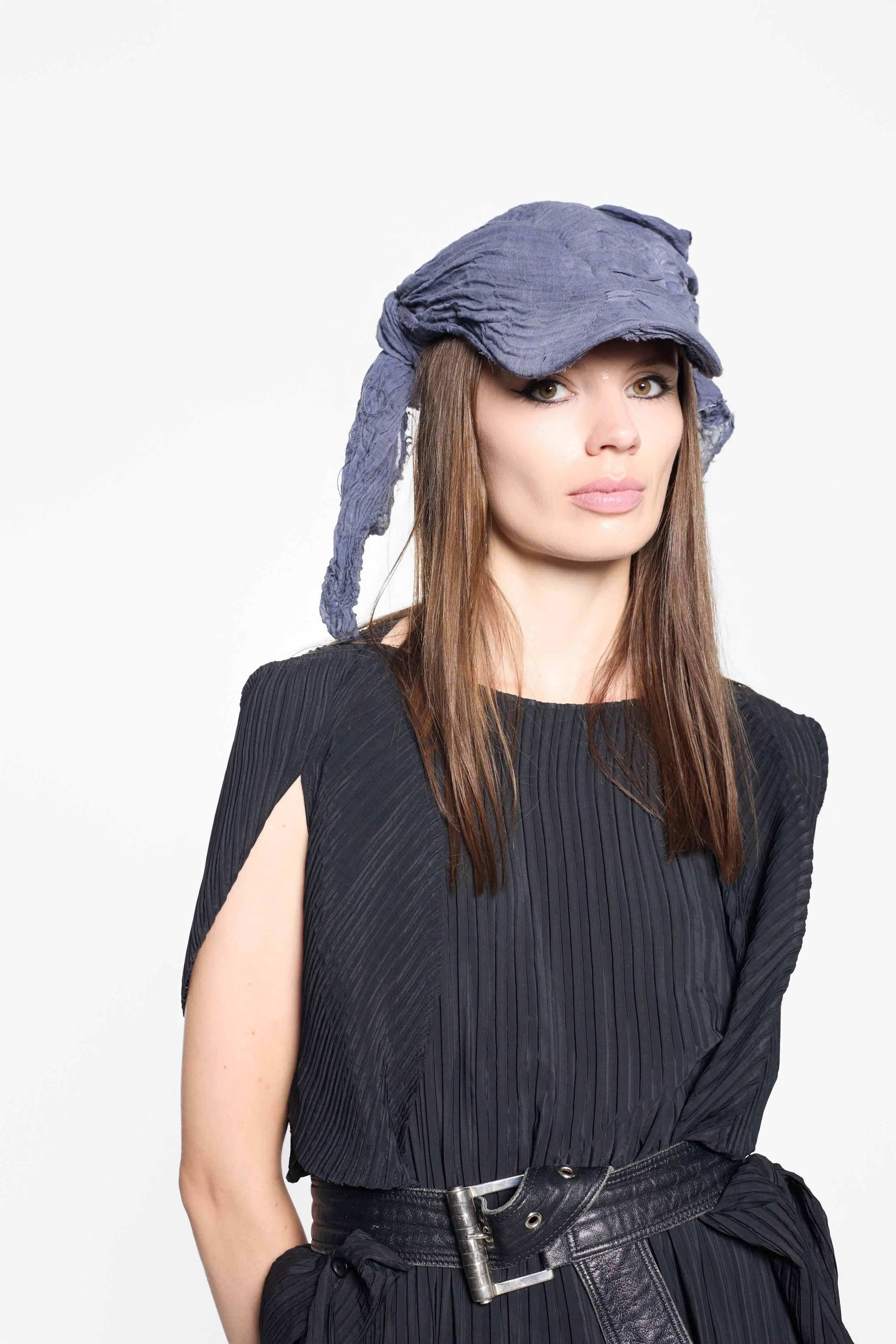 Model wearing MVUDSLYDE slate grey draped wrap cap