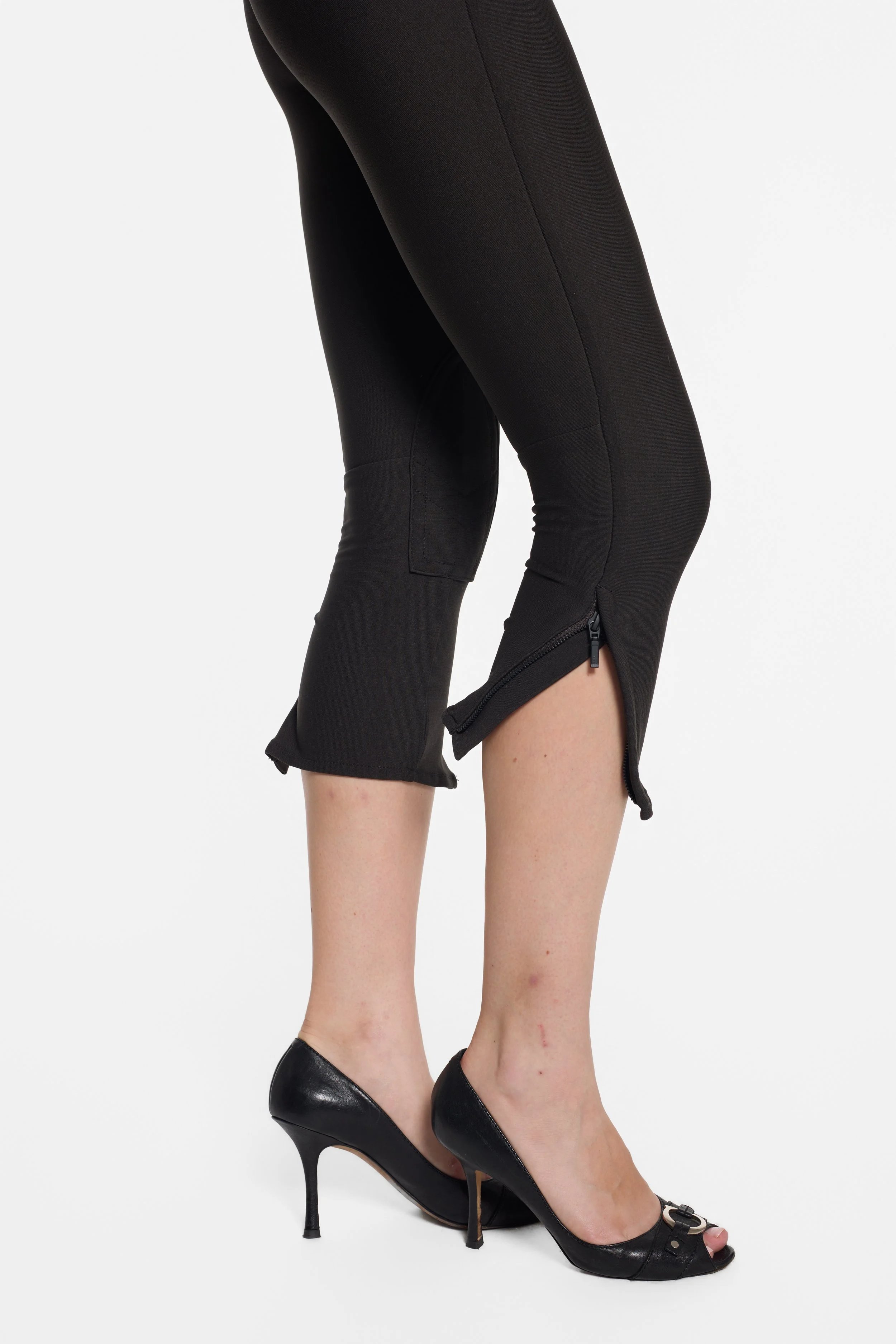 Detail of side-opening zip hem and fitted nylon stretch fabric on LUXXM capris