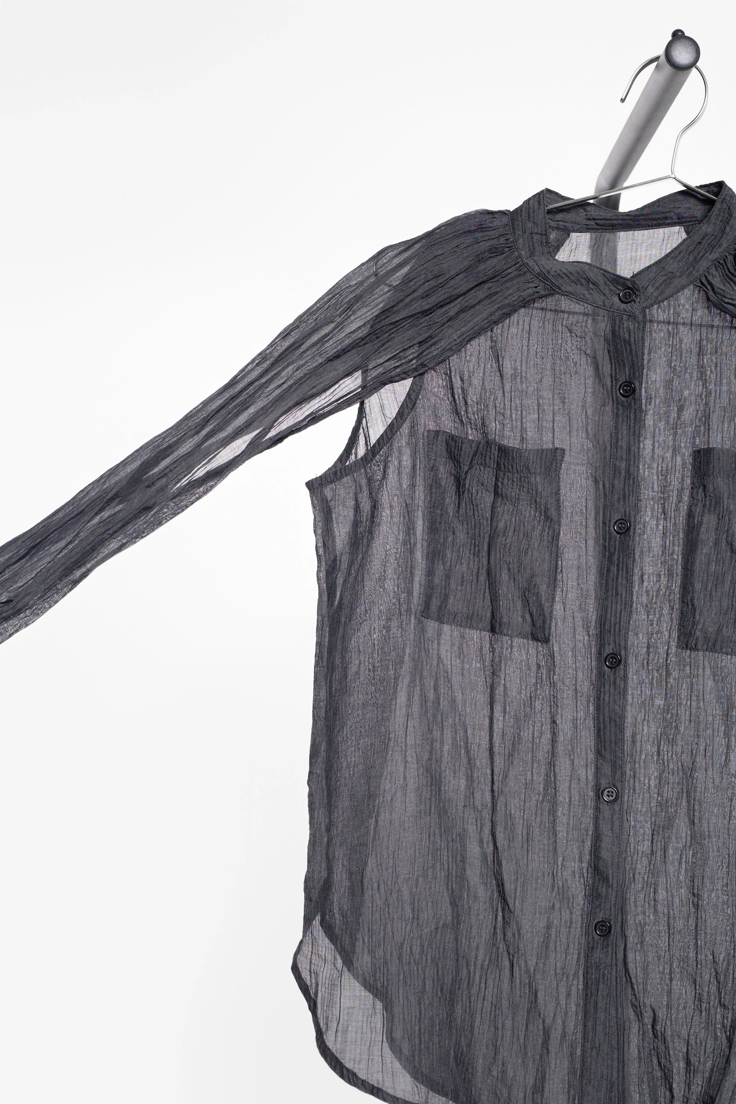 Pitless black semi-sheer shirt with split sleeve construction