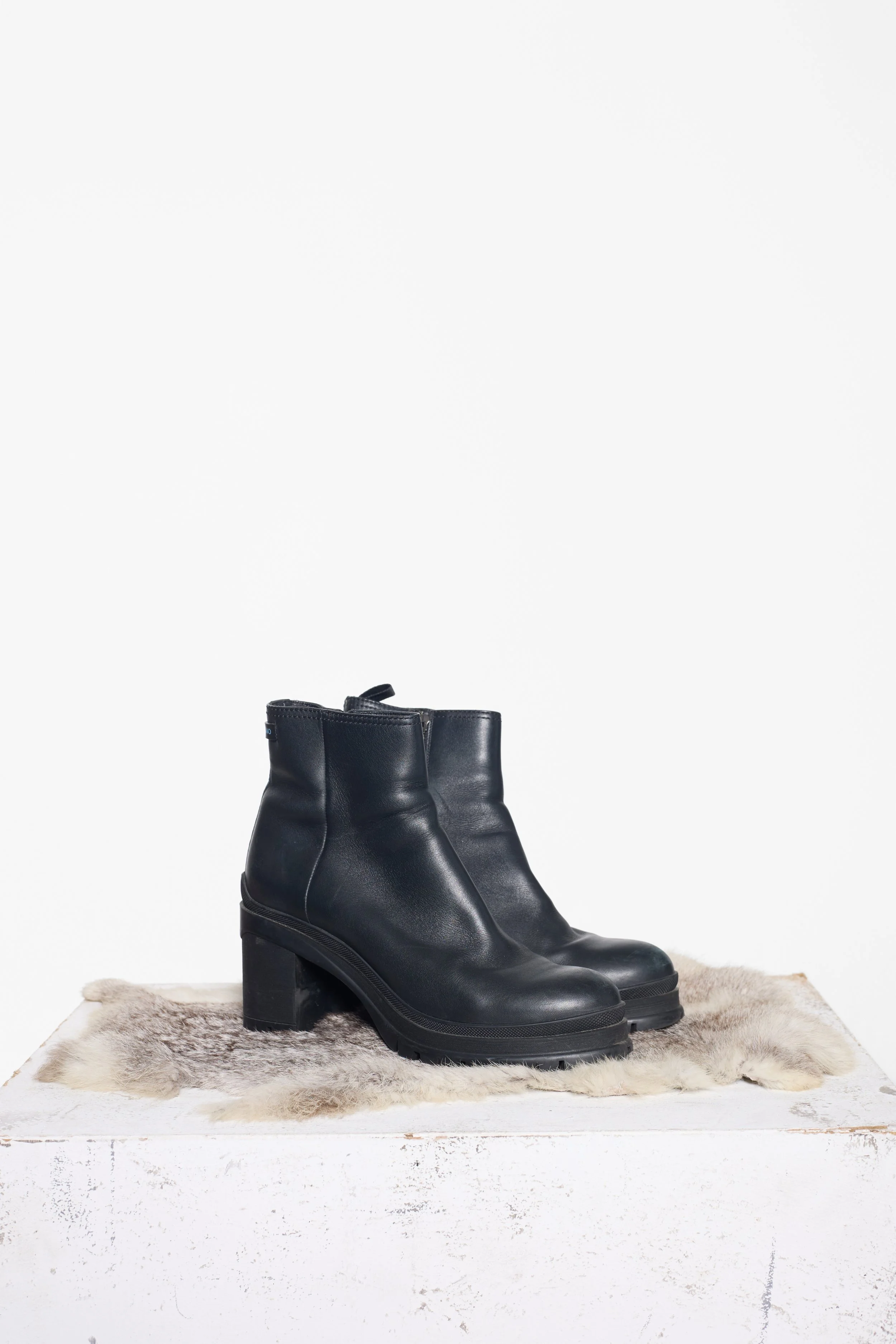 Black Prada lug sole ankle boots showing rounded toe and structured leather upper
