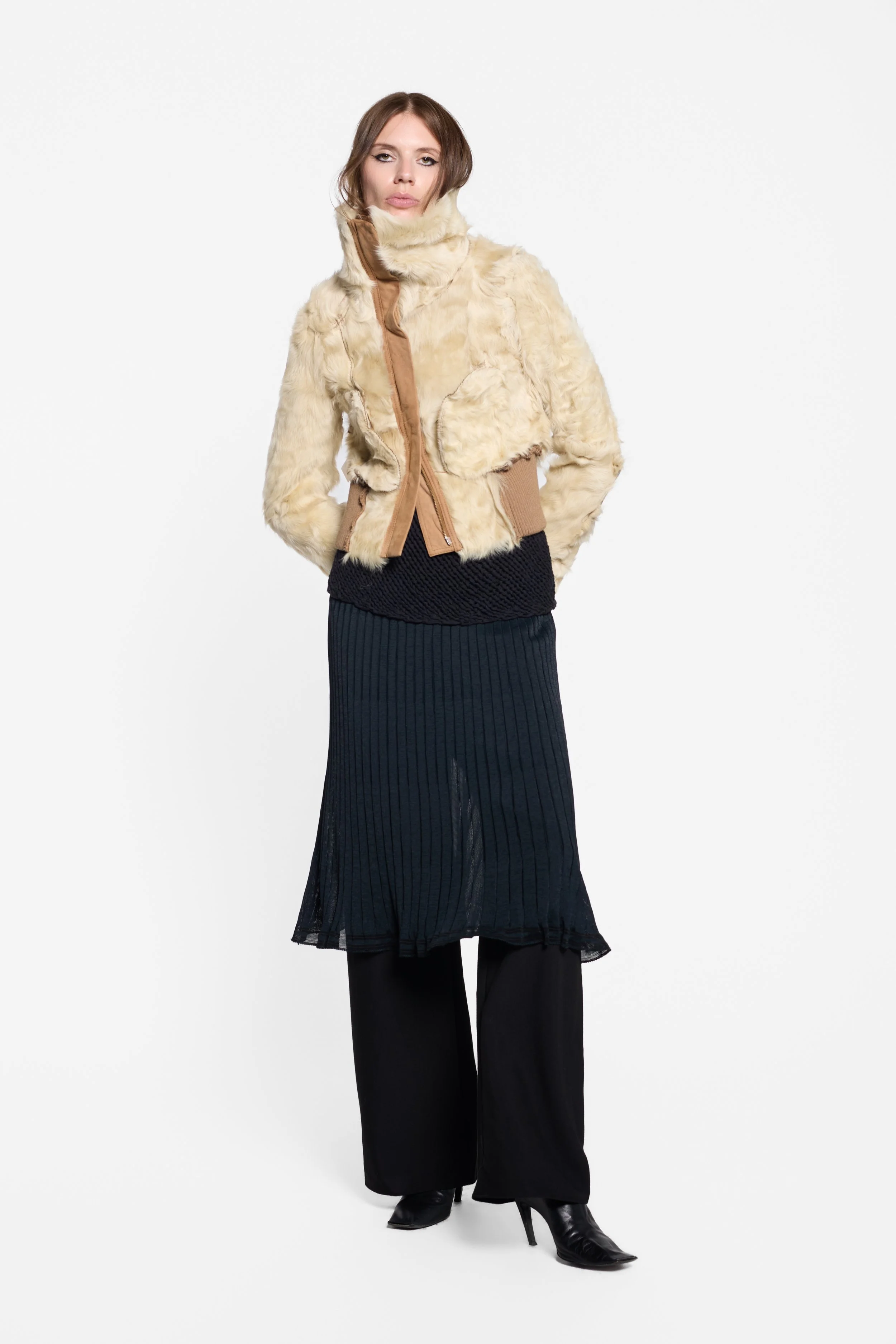 Full-length editorial view of the full Vince black textured knit vest look