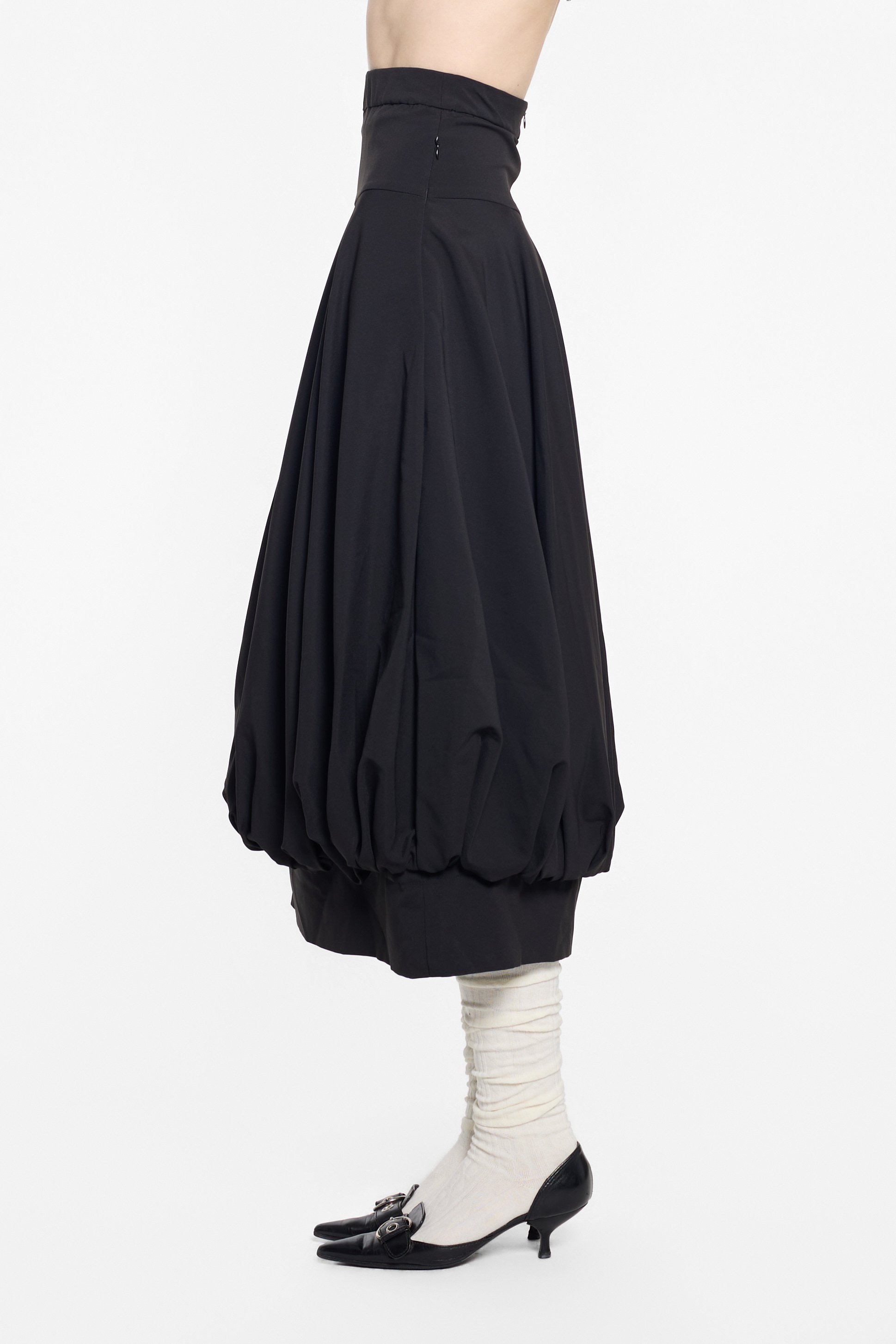 Side view of UN3D sculptural skirt with rounded volume